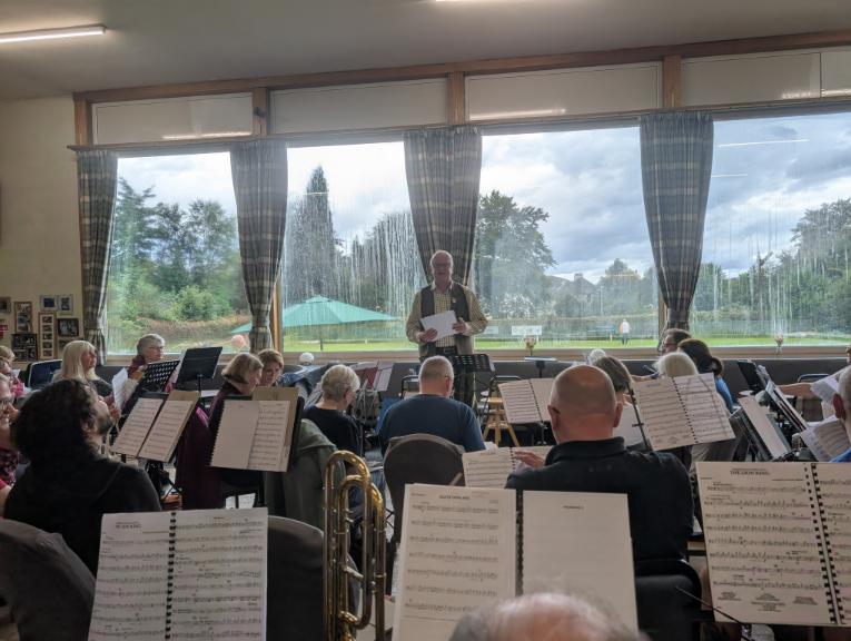 A photograph of the band and conductor Kevin Lamb